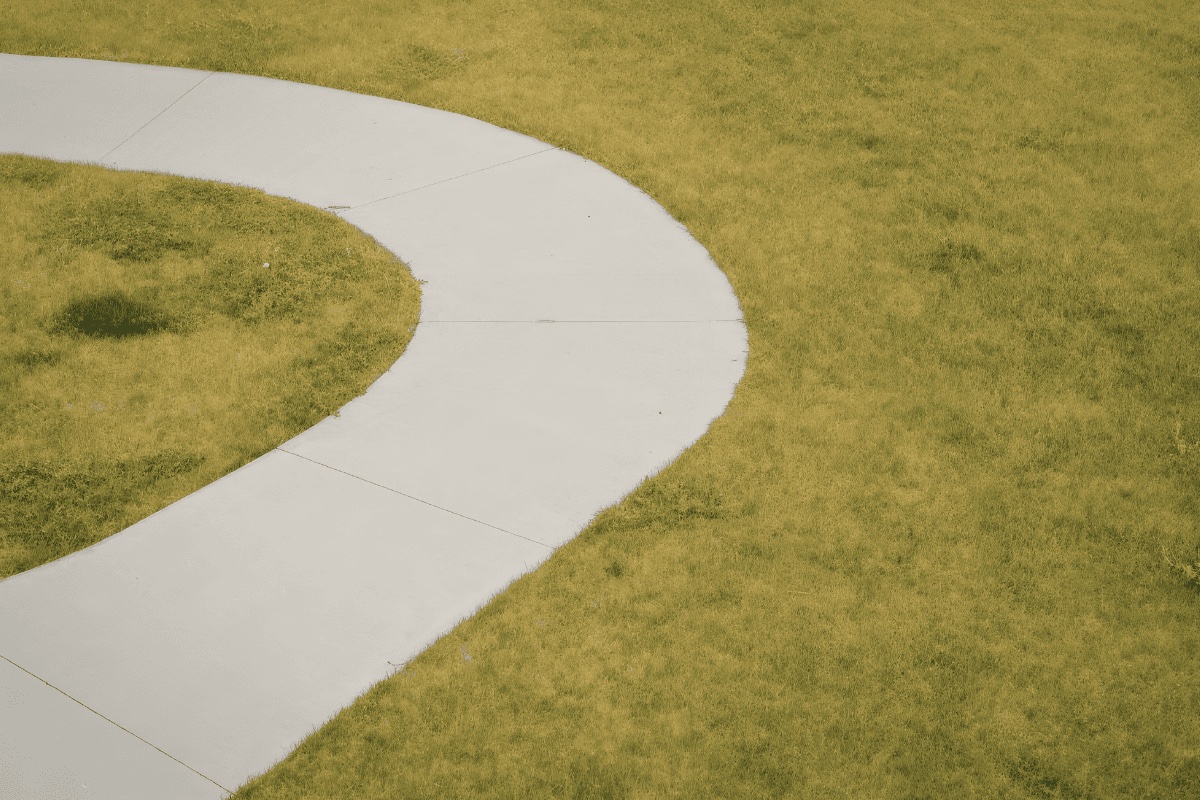 Curved concrete walkway with exposed aggregate