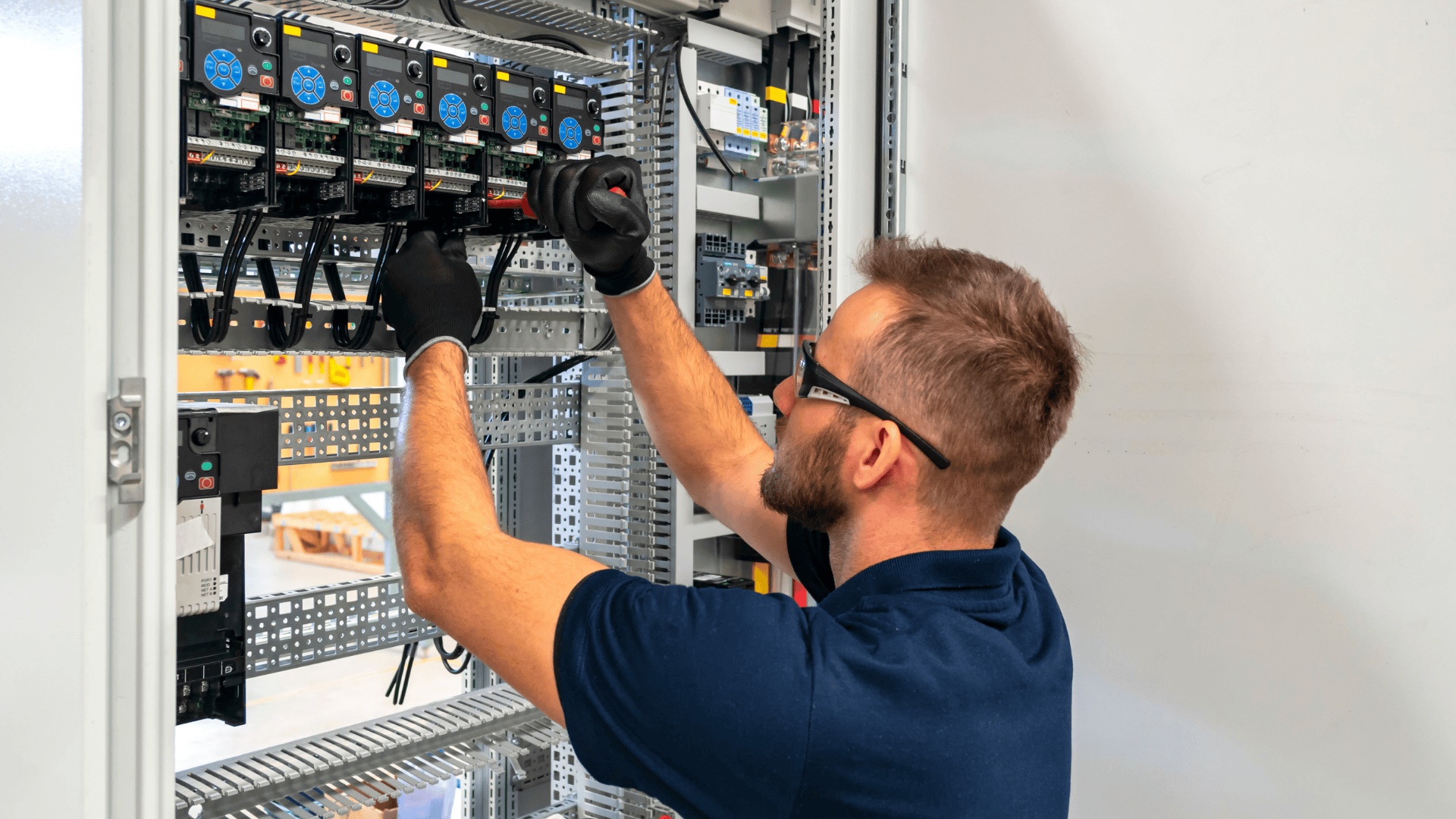 Electrician working on electrical panel