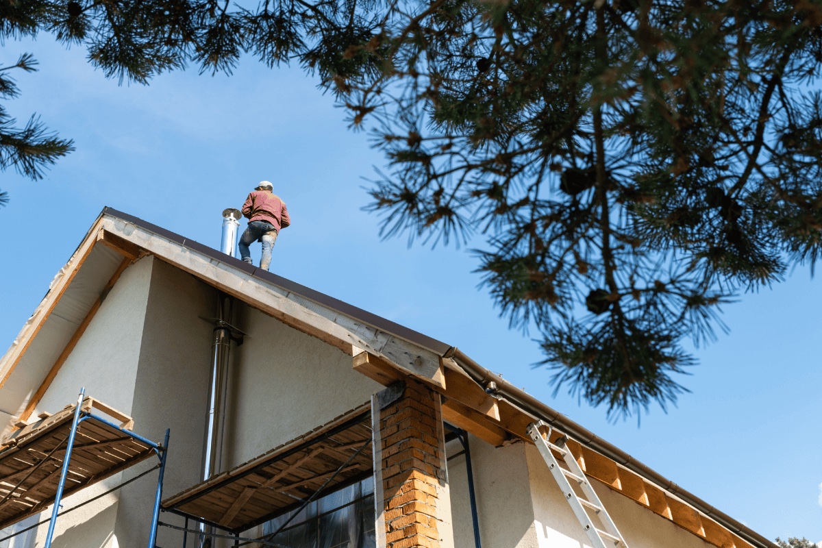 Roofer repairing storm-damaged roof